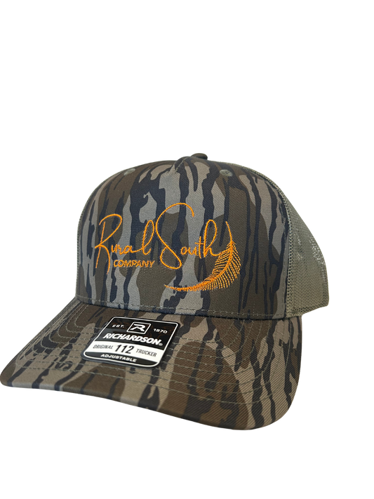 Rural South Company – Bottomlands Camo Trucker Hat (Orange Logo)